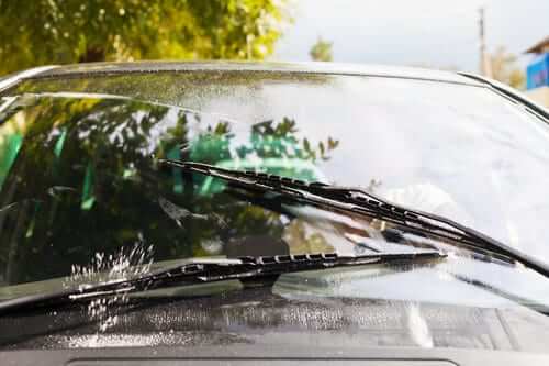Wipers wash windshield