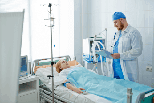 patient talking to a doctor on a hospital bed
