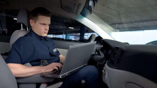 Policeman working on laptop
